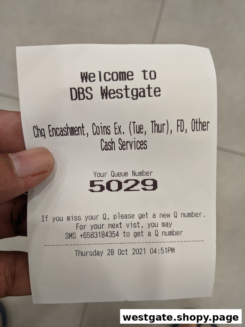 A close-up of a DBS Westgate queue ticket showing banking services and queue number.