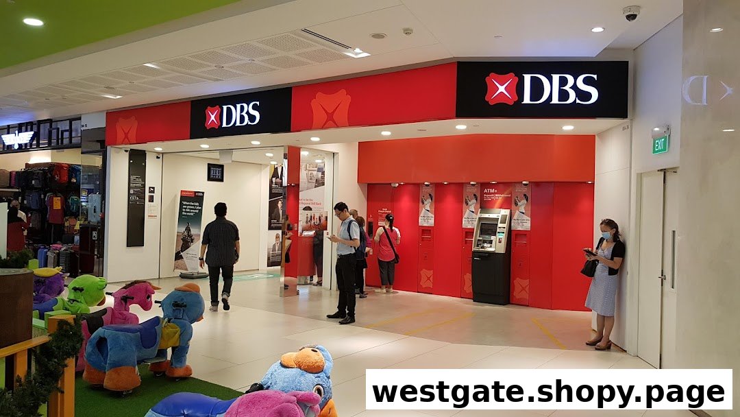 The entrance of DBS Bank Westgate Branch with ATMs and customers inside a shopping mall.