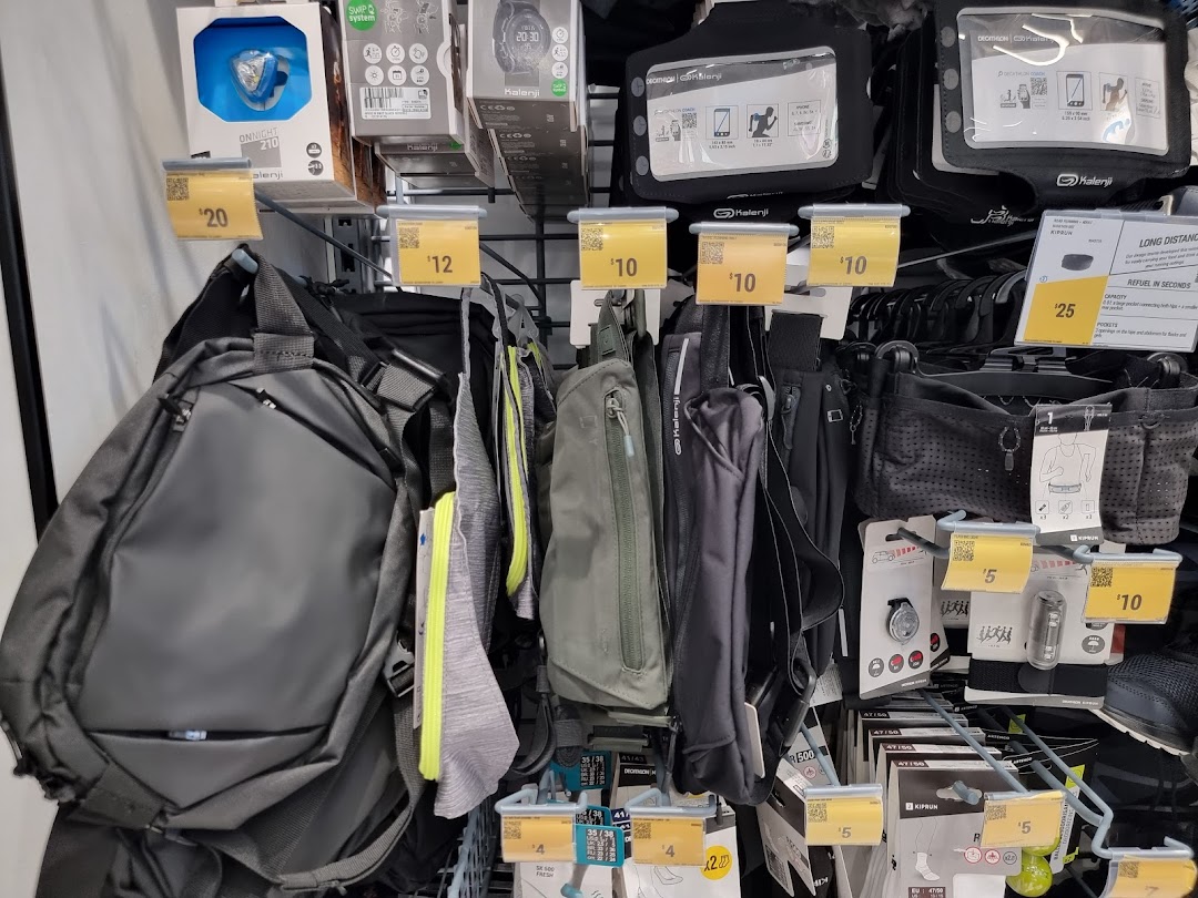 A close-up view of various sports accessories, including bags, phone holders, and lights, displayed with price tags.