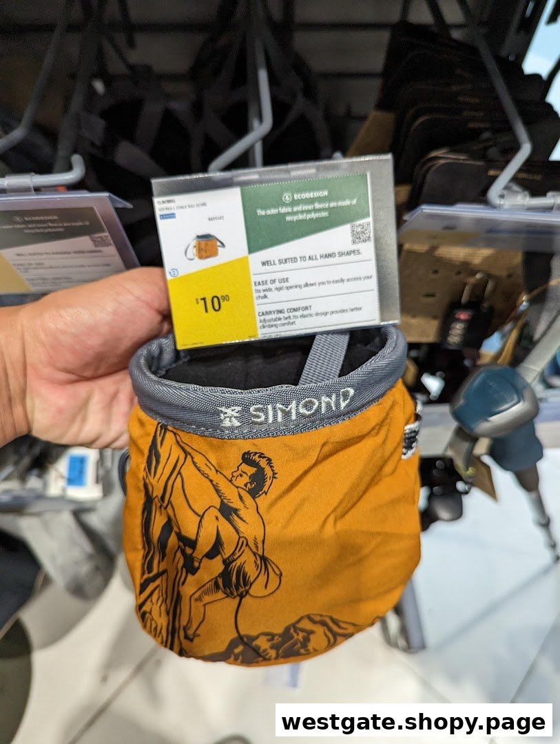 A hand holds a yellow climbing chalk bag with a $10.90 price tag and climber graphic.
