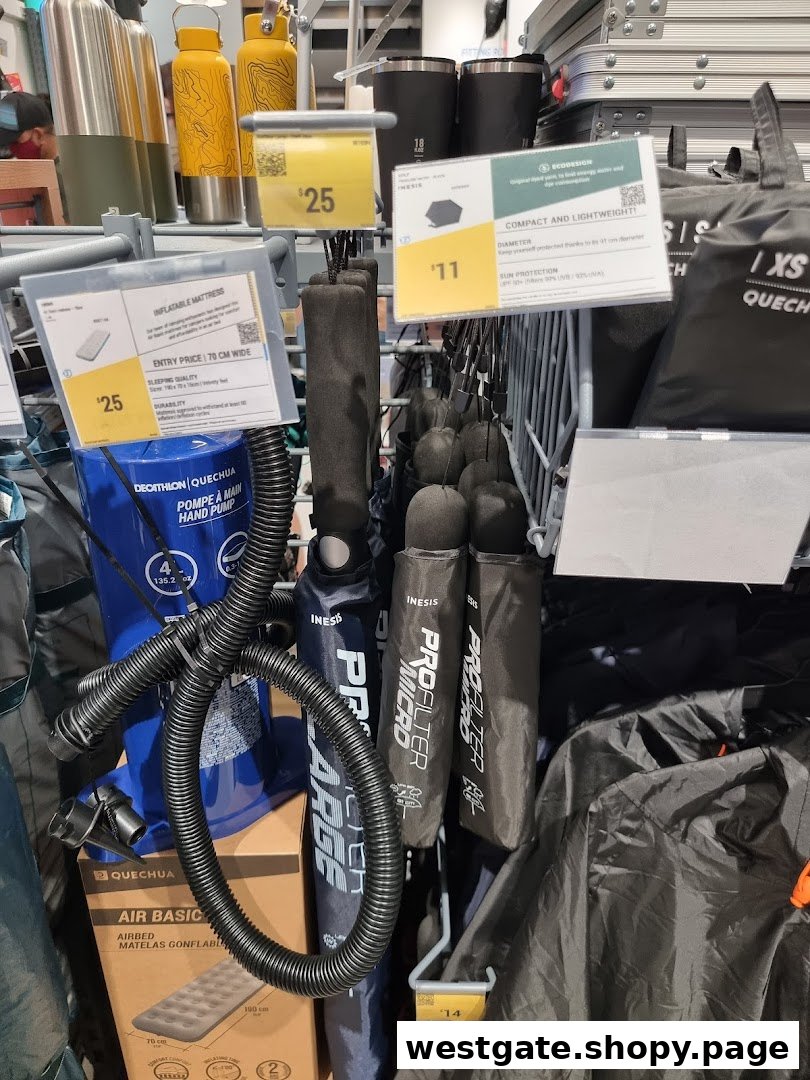 A retail display showcasing various outdoor and camping gear, including inflatable mattresses, hand pumps, and compact shelters.
