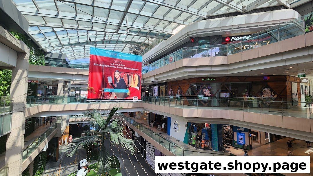 A multi-level shopping mall interior showcasing various retail outlets, including a Decathlon Click & Collect point.