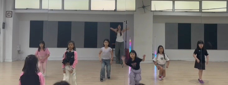 Children actively participating in a dance class with an instructor at DF Academy.