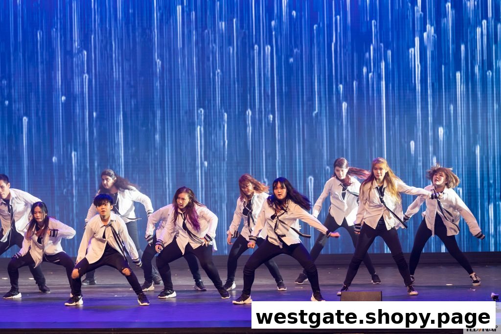 A group of dancers performing on a stage with a dynamic blue light background.