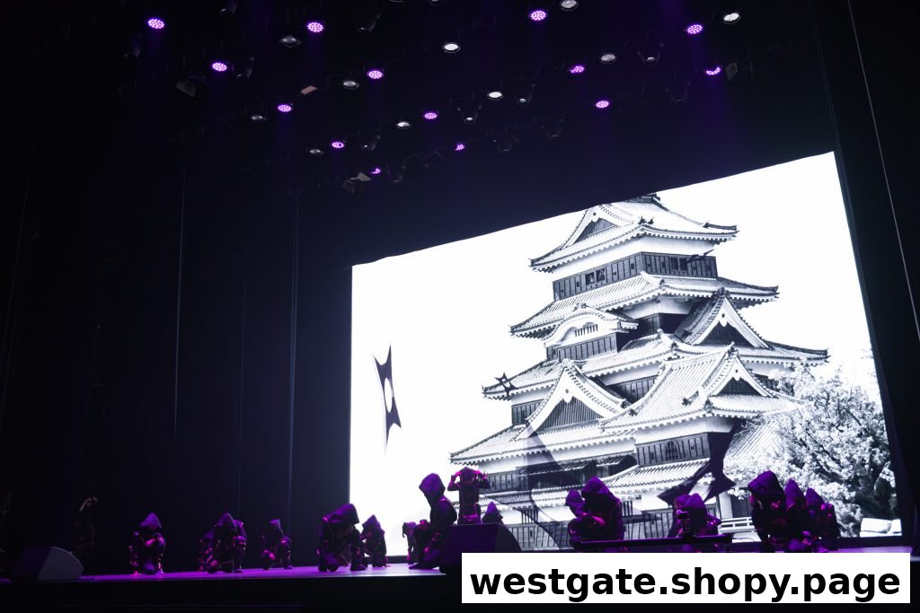 Performers on stage with a large screen displaying a Japanese castle, under vibrant purple lighting.