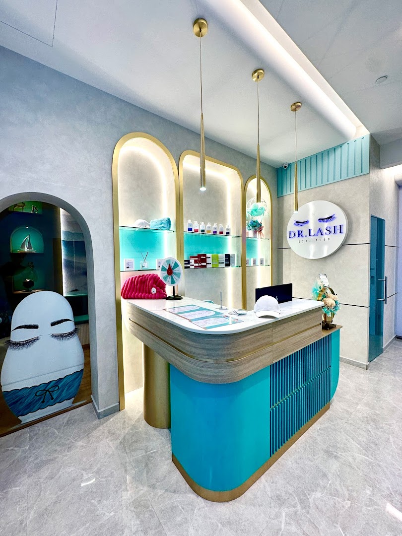A modern and inviting reception area with a teal and gold counter at DR. LASH.