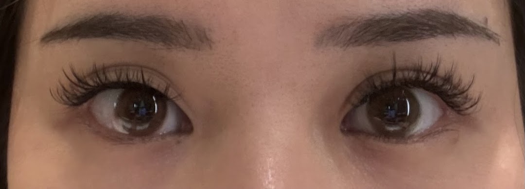 Close-up of eyes showcasing beautifully applied lash extensions, highlighting the quality of service.