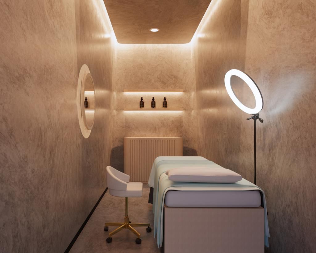 A modern, minimalist treatment room with a bed, ring light, and products on a shelf.