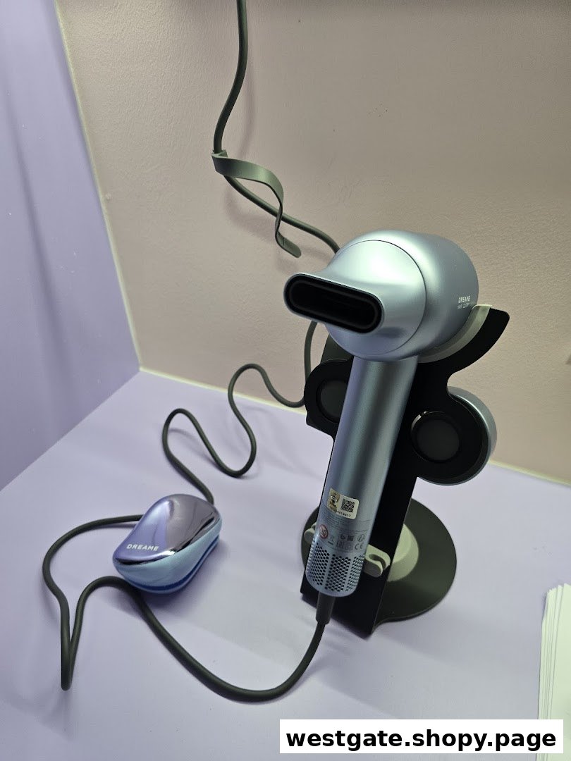 A sleek silver Dreame hair dryer and a smaller device displayed on a light purple surface.