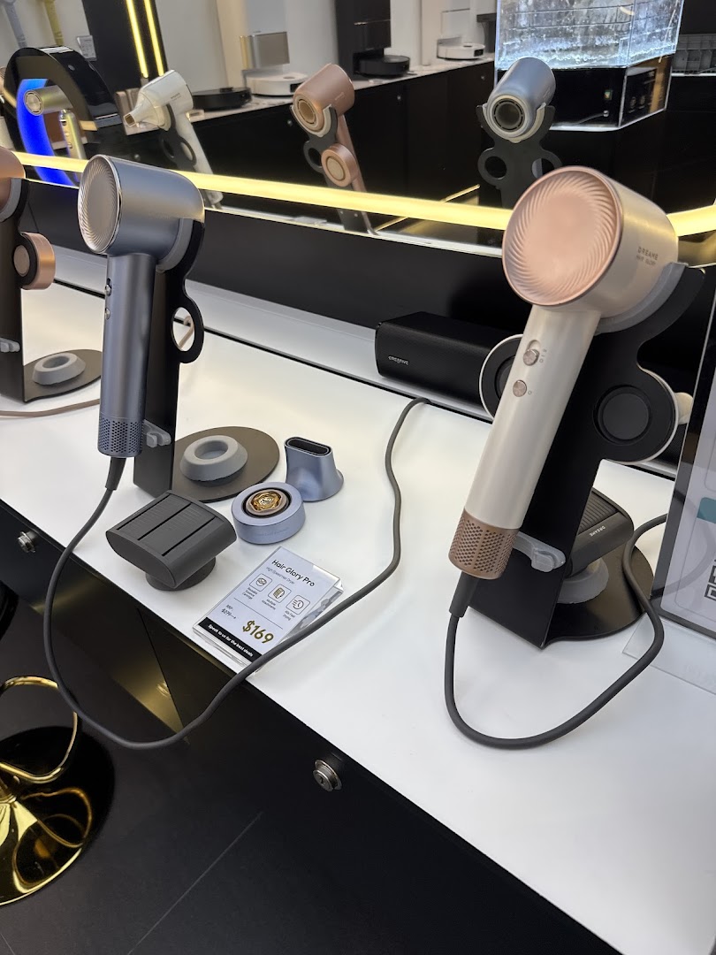 Sleek Dreame Hair Glory Pro hair dryers and accessories displayed in a modern retail setting.