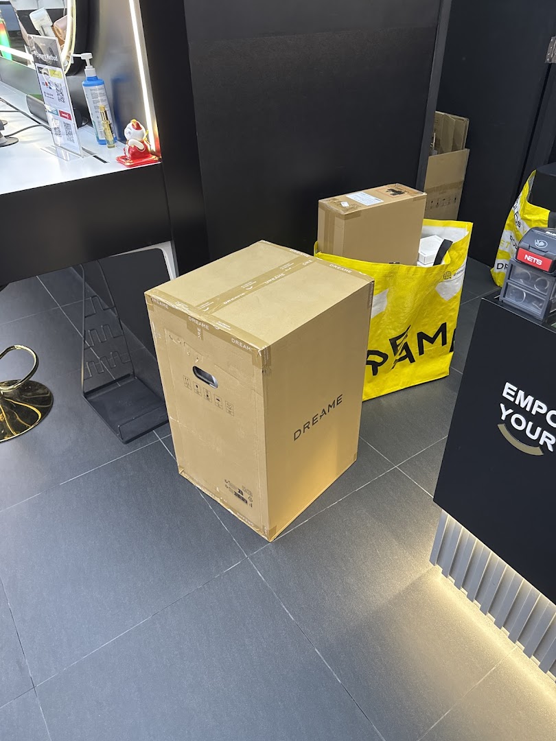 Interior shot of Dreame Westgate showing product boxes and a yellow branded bag on the floor.