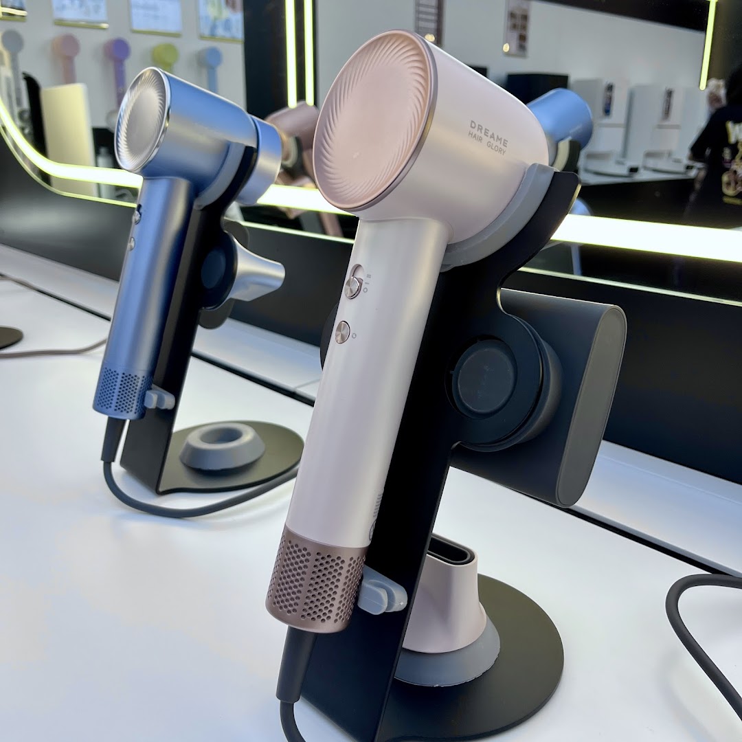 Close-up of two Dreame Hair Glory hair dryers on display in a retail store.