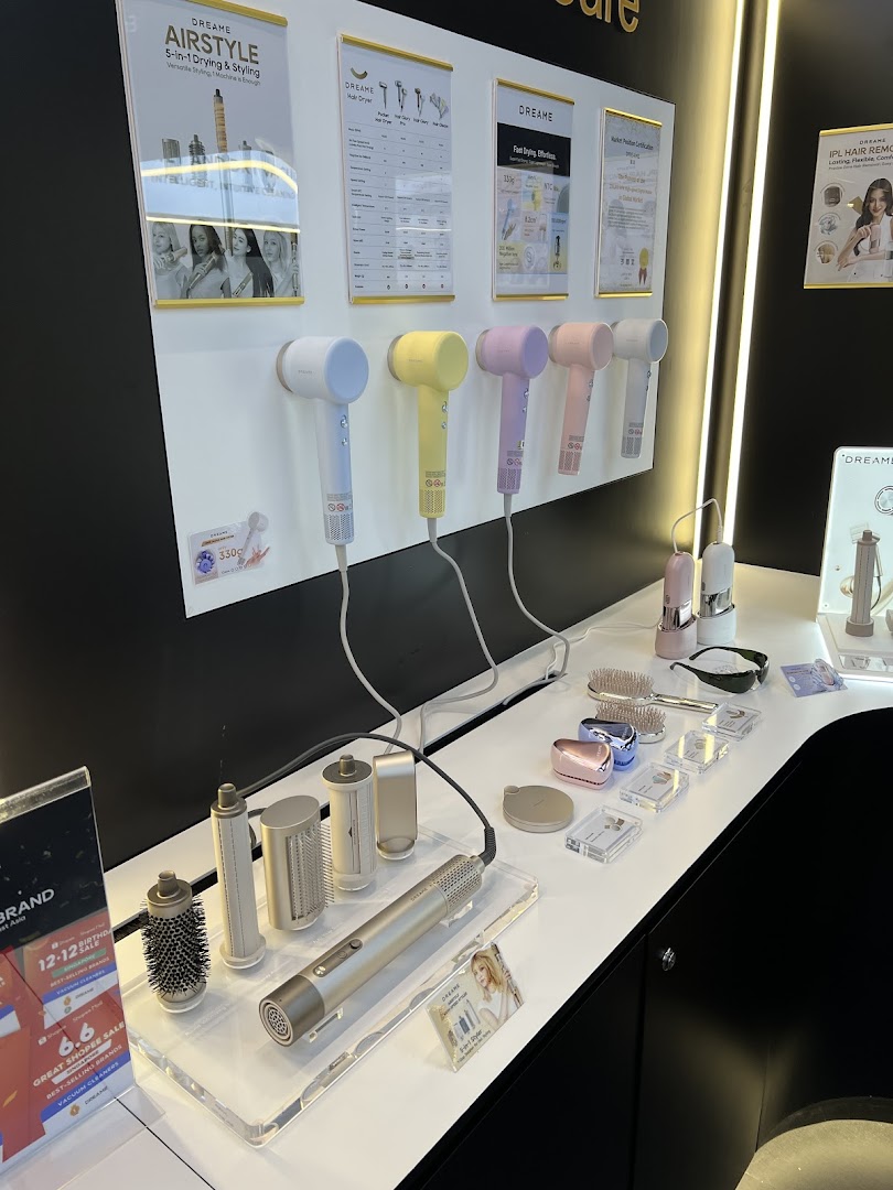 A display of Dreame hair styling tools and beauty devices, featuring colorful hair dryers and multi-stylers.