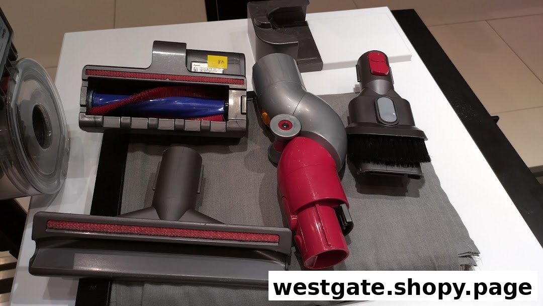 Close-up of various Dyson vacuum cleaner attachments and accessories on display.