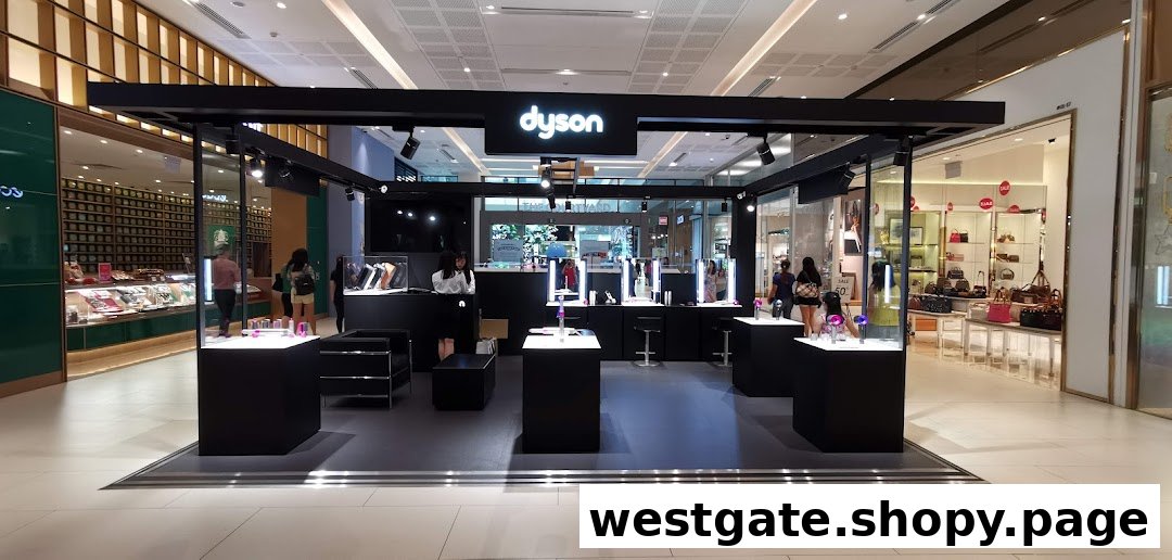 A modern Dyson retail kiosk showcasing various innovative products with customers interacting.