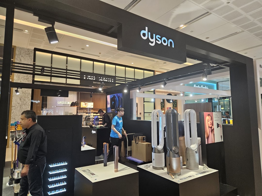 An interior view of the Dyson store showcasing innovative home technology products and staff.