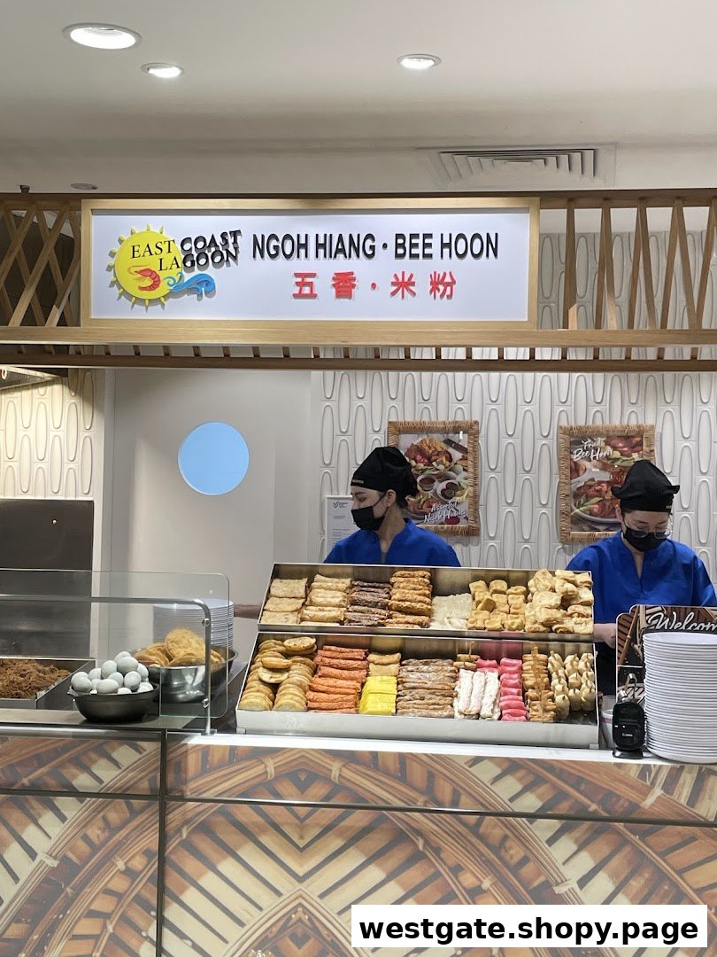 Two staff members behind a counter displaying a variety of Ngoh Hiang and Bee Hoon ingredients.