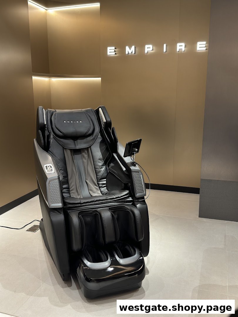 A luxurious black massage chair displayed in a modern showroom with the EMPIRE logo.