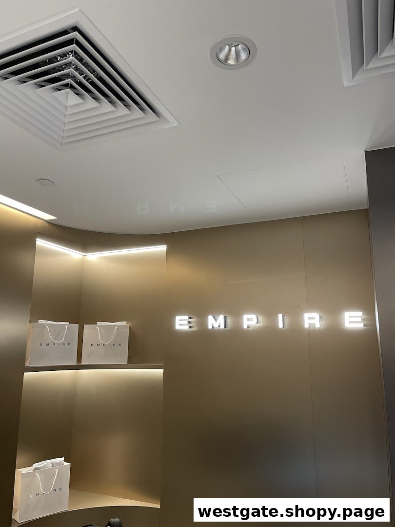 Interior shot of EMPIRE store featuring illuminated branding and display shelves with shopping bags.