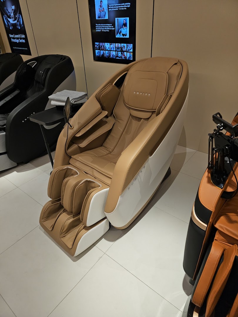 A luxurious tan and white massage chair displayed prominently in a retail showroom.