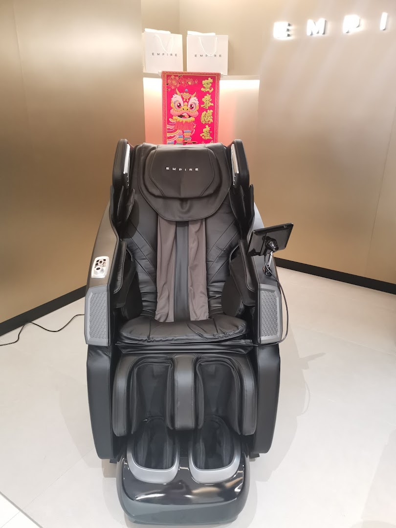 A luxurious black massage chair displayed prominently inside the EMPIRE store.