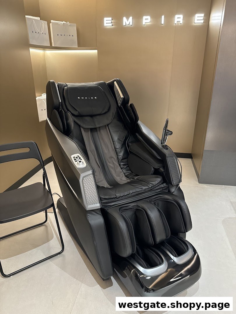 A luxurious black massage chair displayed in a modern retail setting under the 'EMPIRE' brand.