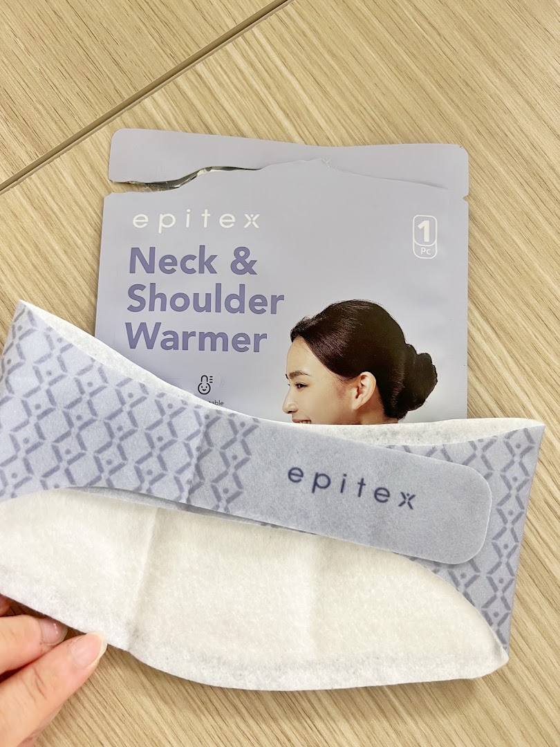 Close-up of an Epitex Neck & Shoulder Warmer product and its packaging on a wooden surface.