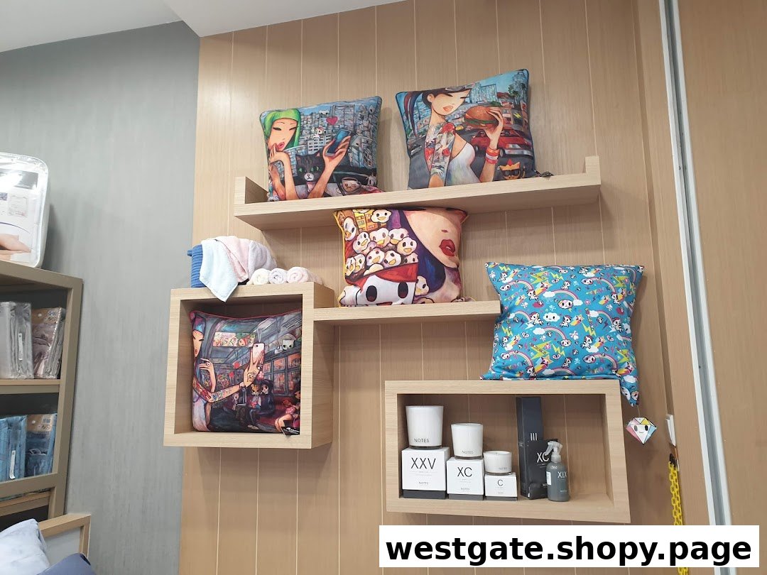 A stylish wall display at Epitex featuring artistic decorative pillows, home fragrances, and rolled towels.