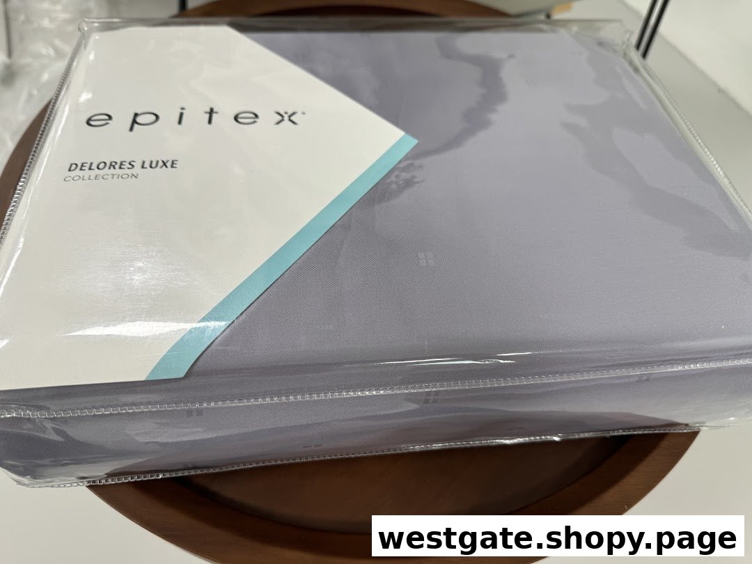 A packaged Epitex 'Delores Luxe Collection' bedding set in a soft grey color.