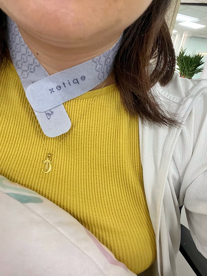 A person wearing a grey neck product with the Epitex logo, showcasing comfort and quality.