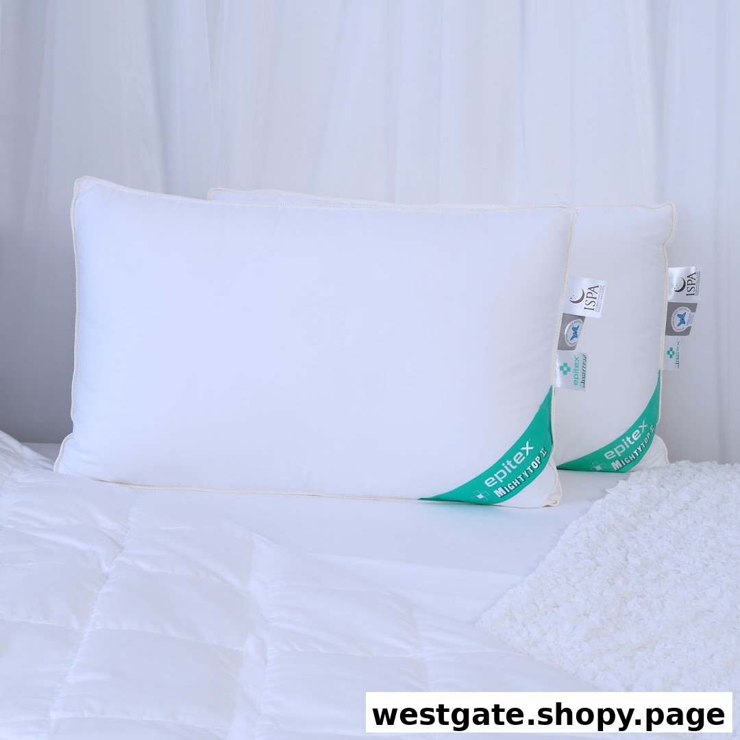 Two white Epitex pillows with green labels are displayed on a bed with white bedding.