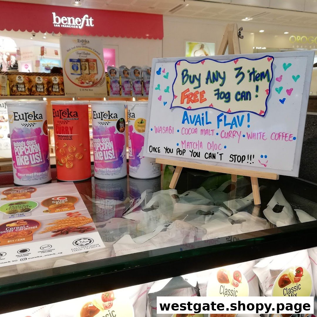 A display of Eureka gourmet popcorn cans with a promotional sign for available flavors and a special offer.