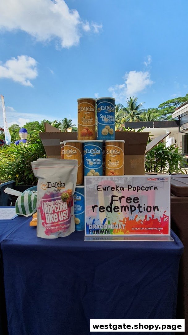 A display of Eureka Popcorn products on a table with a sign for free redemption.