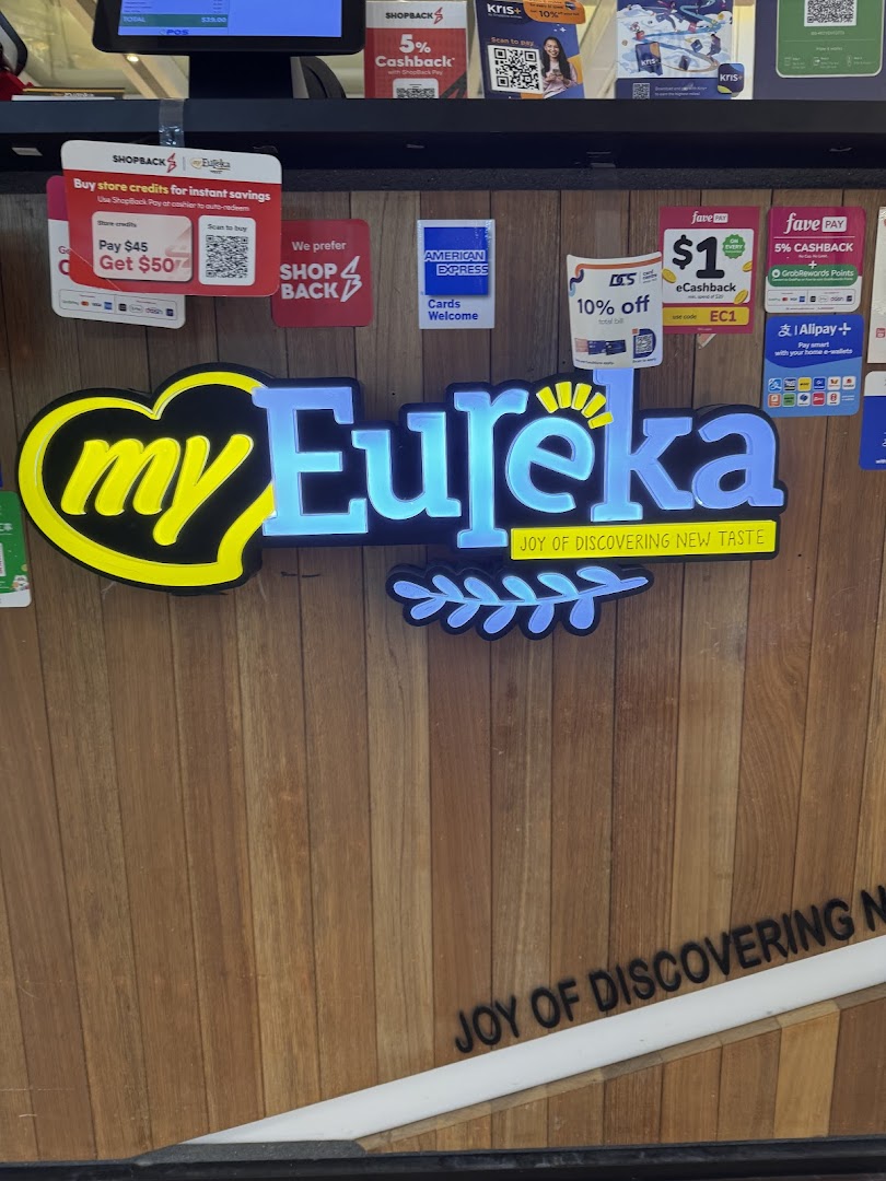 The Eureka Popcorn counter features its illuminated logo and various payment and loyalty program options.