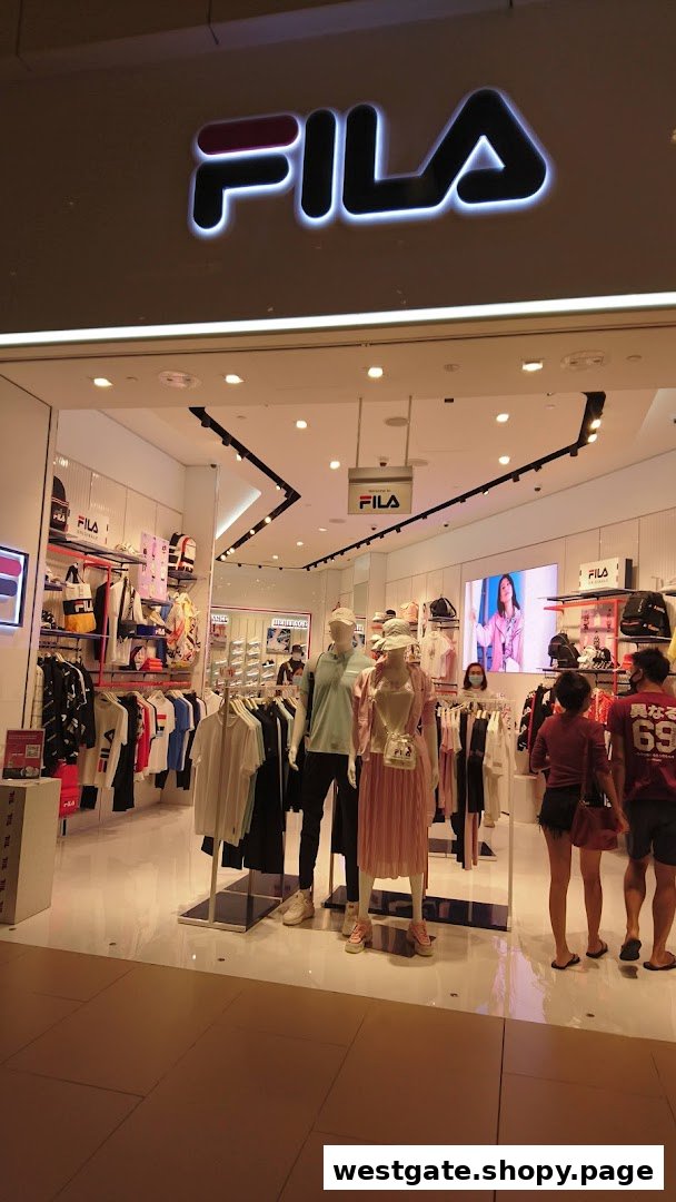 The image shows the brightly lit entrance of a FILA store with mannequins displaying sportswear and accessories.