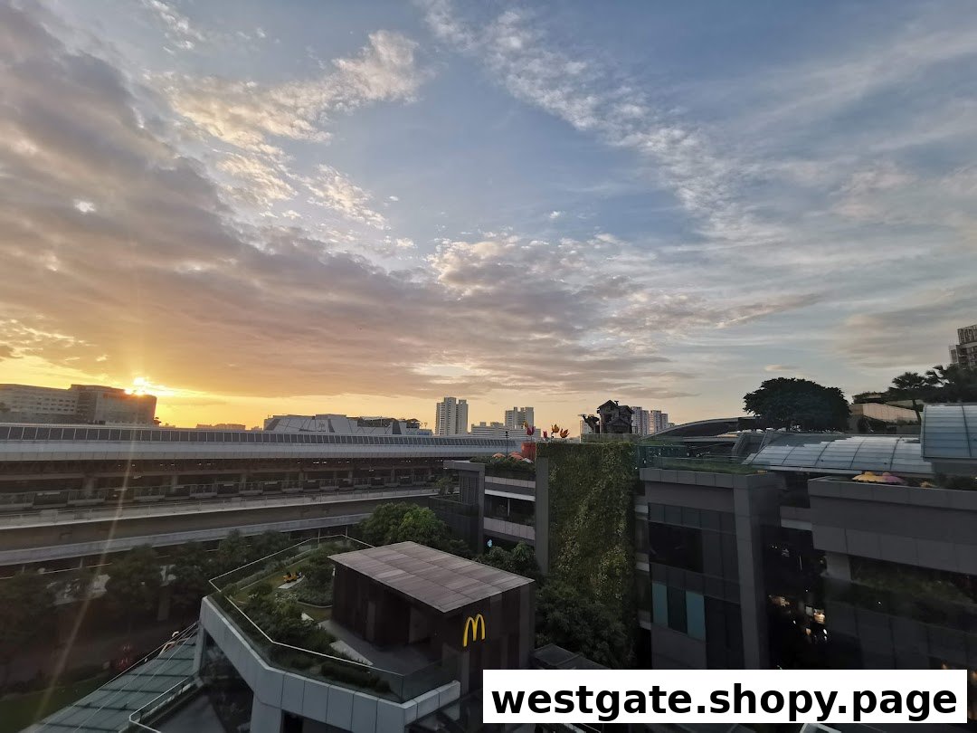 A scenic sunset view over a modern cityscape, featuring buildings, a train track, and a McDonald's logo.