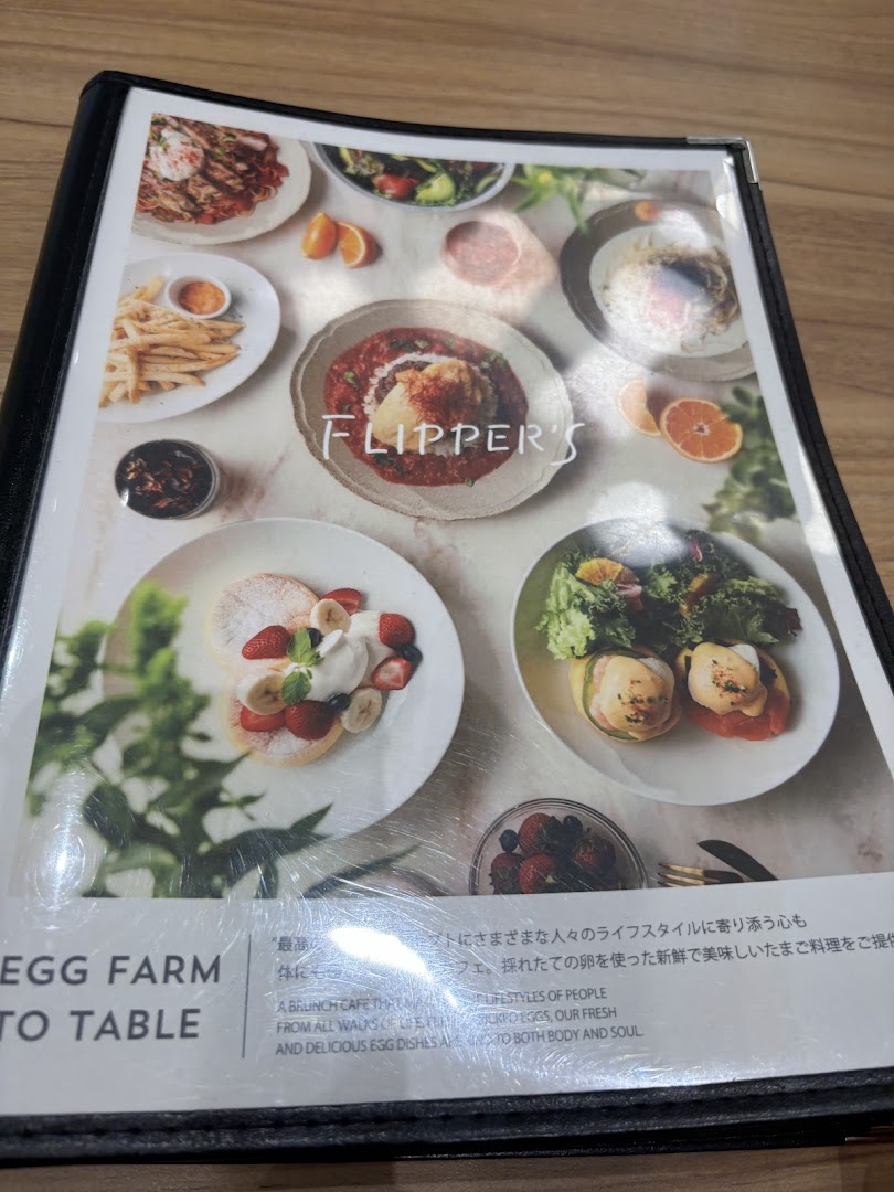 A close-up of Flippers' menu, showcasing various delicious food items and the brand's philosophy.