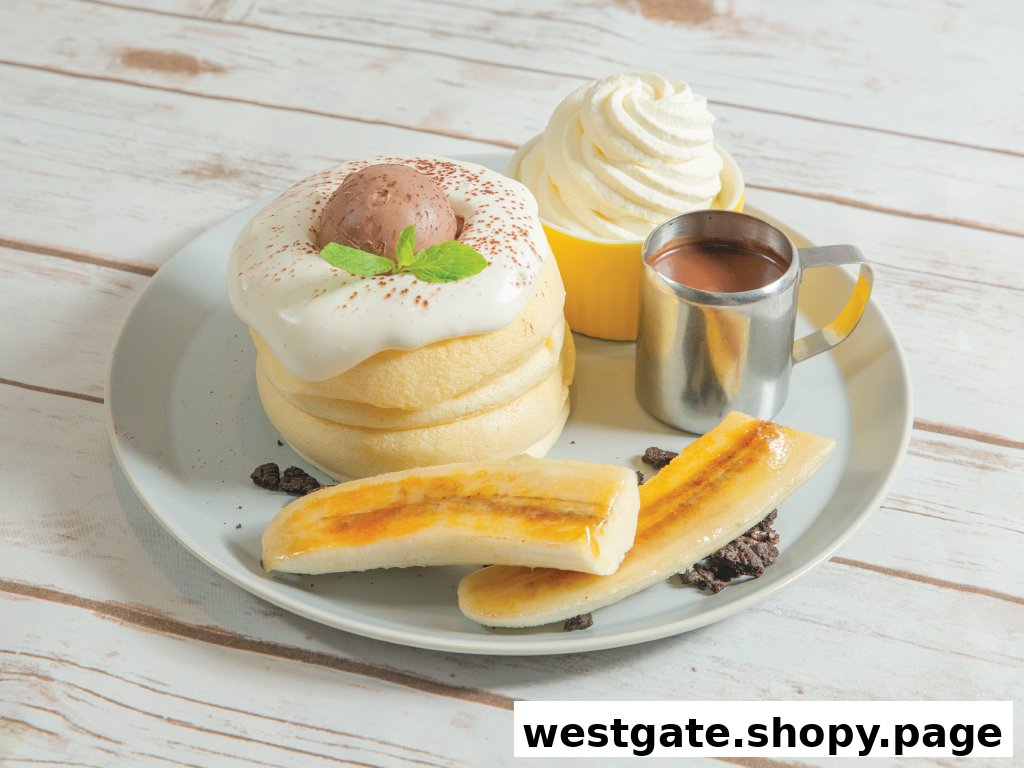 A plate of fluffy soufflé pancakes topped with cream, chocolate ice cream, and caramelized bananas.