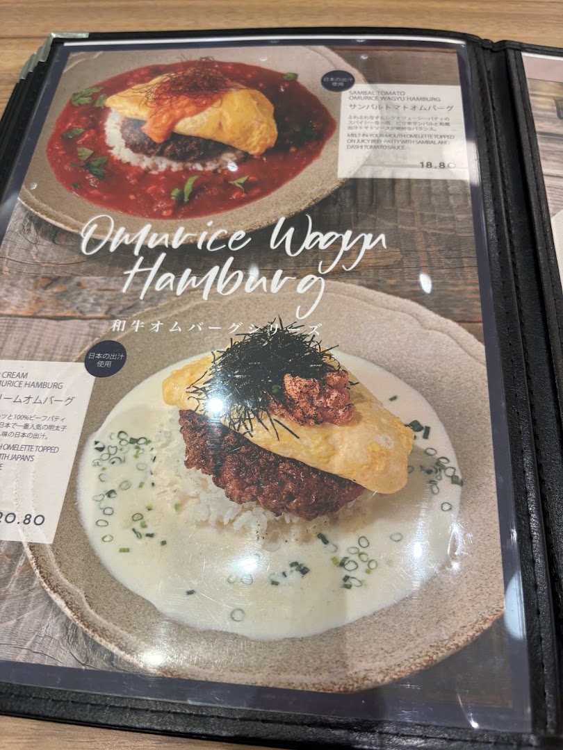 A close-up of a menu displaying two delicious Omurice Wagyu Hamburg dishes with prices and descriptions.