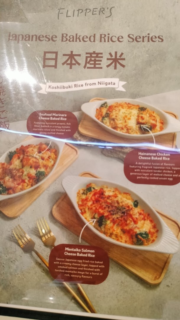 A menu board from Flippers Westgate showcasing their Japanese Baked Rice Series with three distinct dishes.