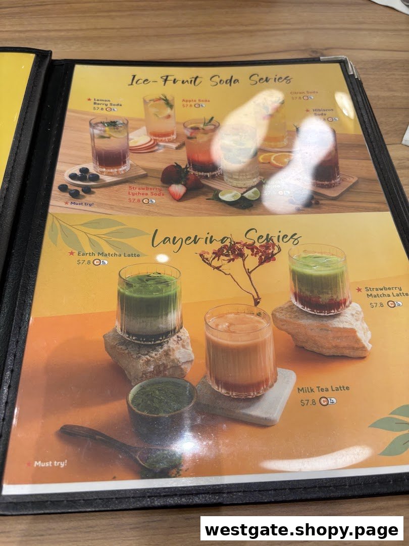 A vibrant menu page showcasing refreshing ice-fruit sodas and layered lattes with prices.