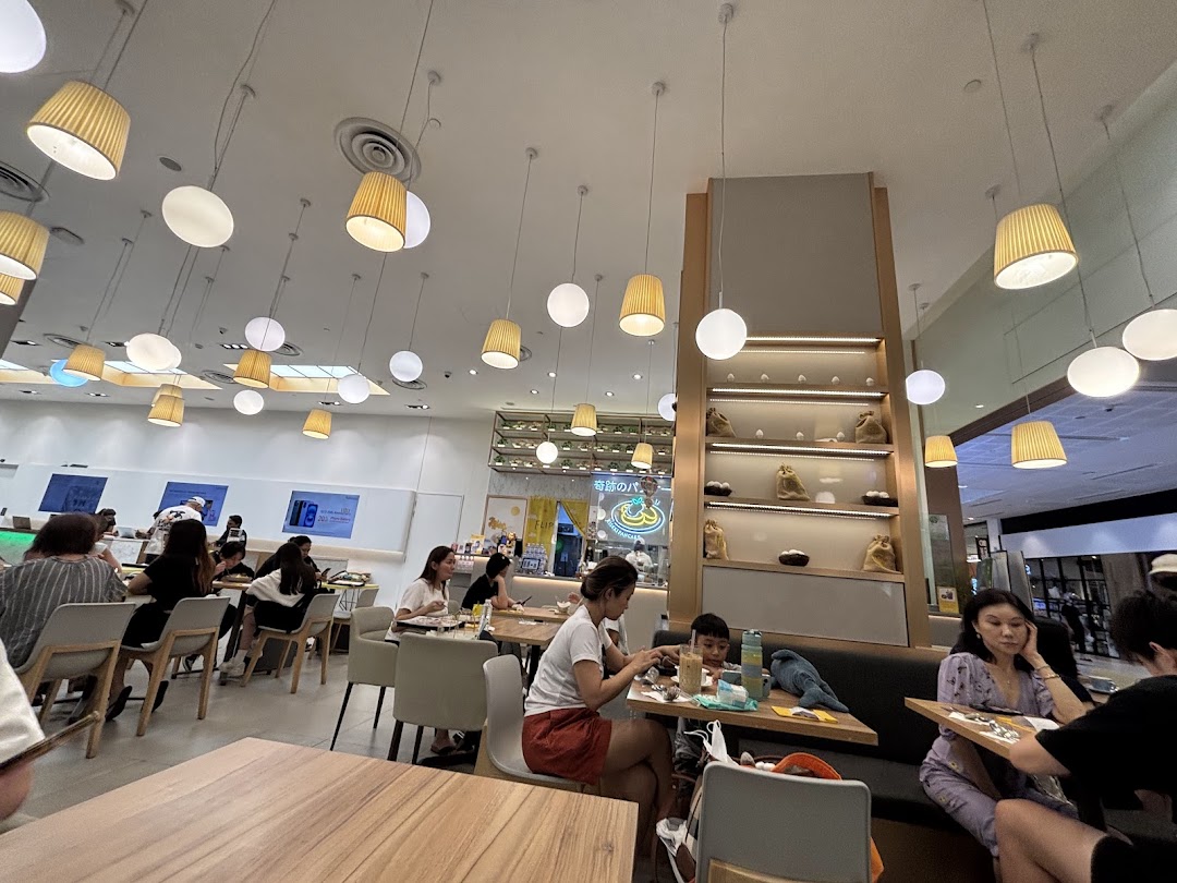 Customers enjoying a meal inside Flippers Westgate, featuring modern lighting and a comfortable dining area.