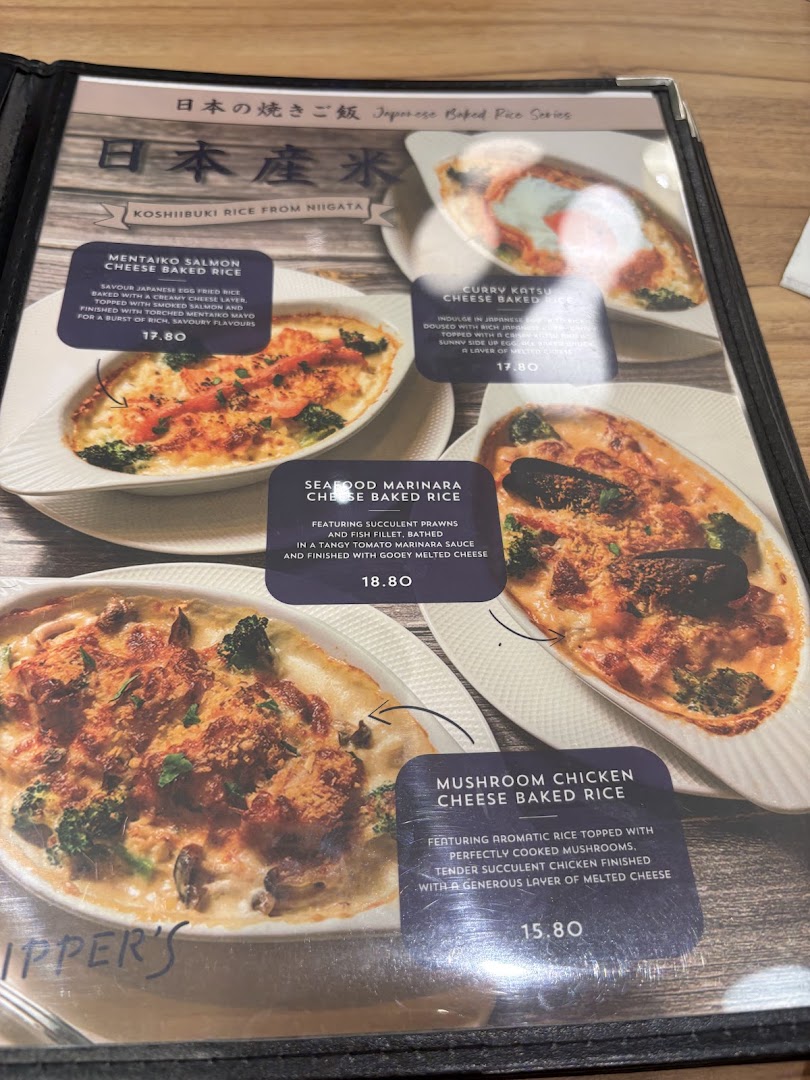 A menu page from Flippers Westgate showcasing various Japanese baked rice dishes with cheese.