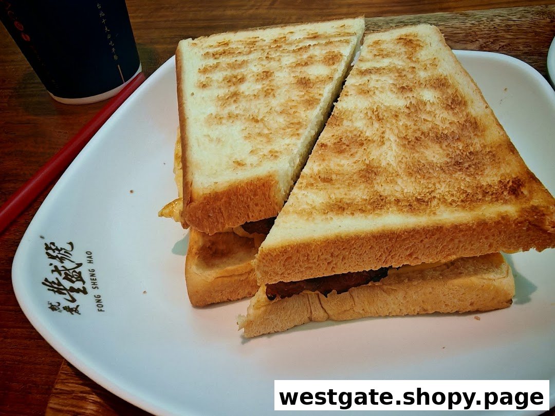 A perfectly toasted sandwich, cut in half, served on a white plate with a drink.