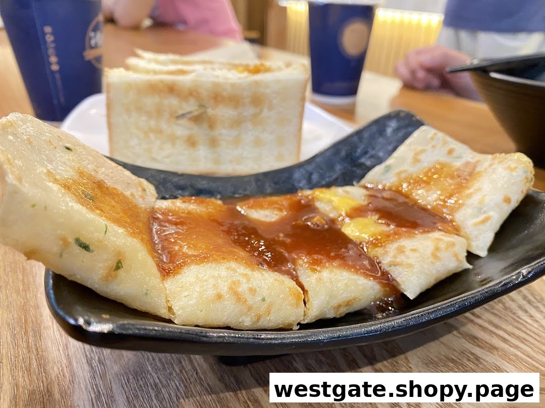 Close-up of a savory pancake dish with sauce, served on a black plate at Fong Sheng Hao.