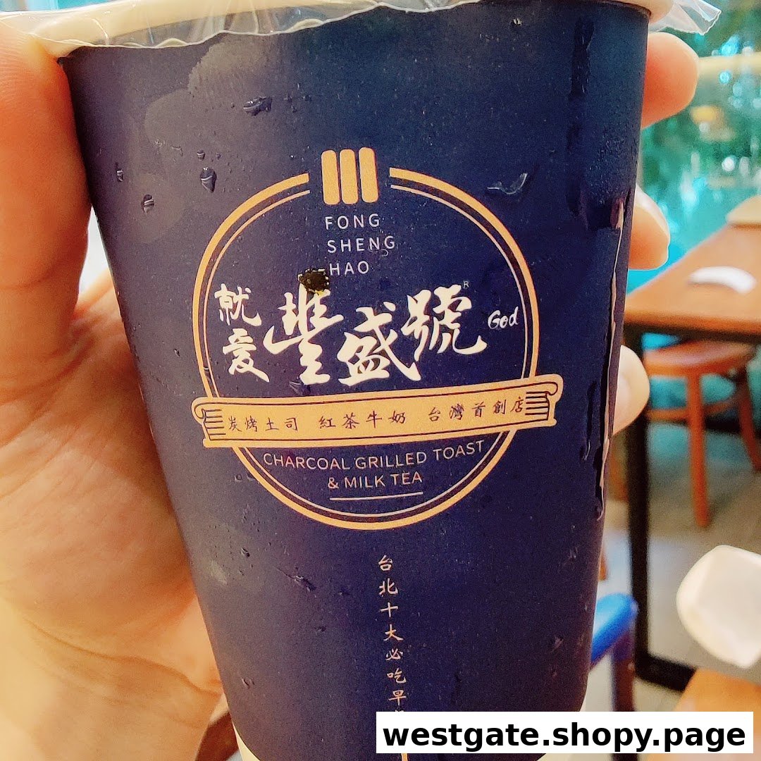 A hand holds a refreshing milk tea cup from Fong Sheng Hao, featuring its distinctive logo.