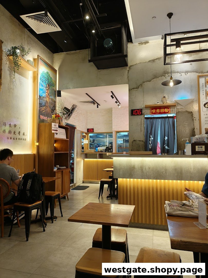 An inviting interior view of Fong Sheng Hao with wooden tables, concrete accents, and warm lighting.