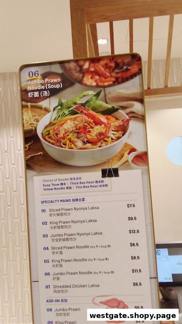 A vibrant menu board displaying various prawn and chicken noodle dishes with prices and noodle choices.
