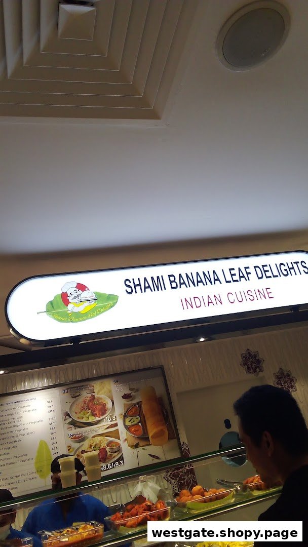 An Indian cuisine food stall, Shami Banana Leaf Delights, with a menu board and food displays.