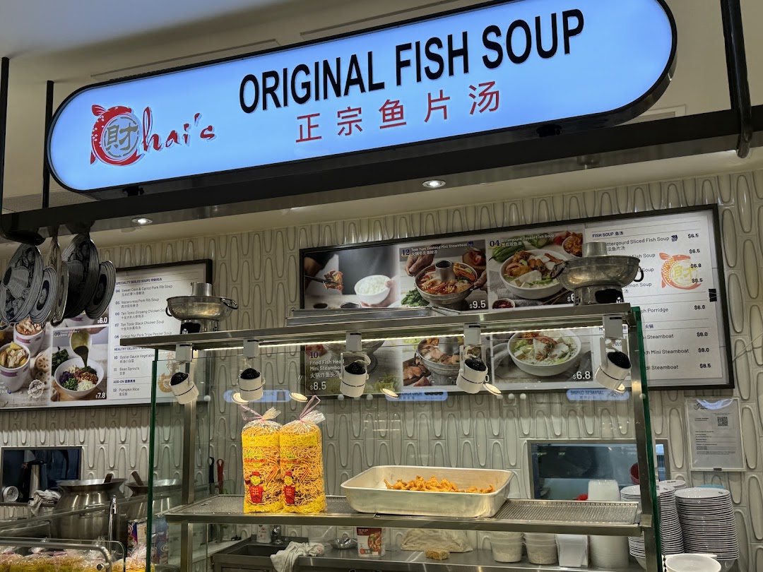 A food stall counter at Food Junction featuring a prominent 'Original Fish Soup' sign and various menu items.